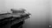 a bridge that abruptly stops in the middle of a foggy void